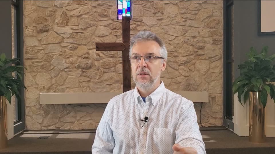 A frame of a Sunday livestream: the pastor small in a wide 16:9 shot